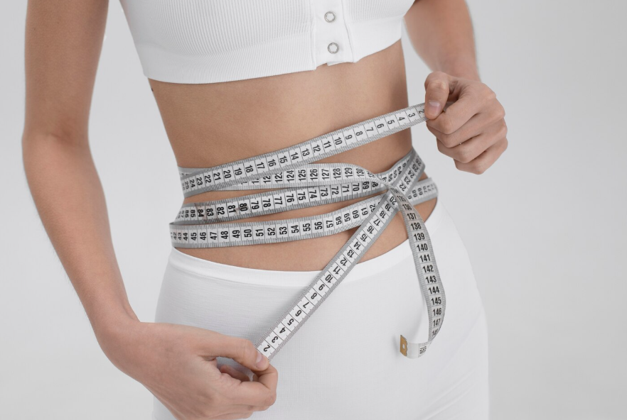 복부에 줄자를 두른 사람